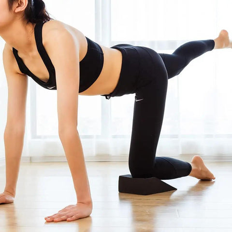 High Grade Foam Yoga Wedge Blocks Set Of Two With Carry Bag Multi Angle Incline support in use during deep stretching exercises.