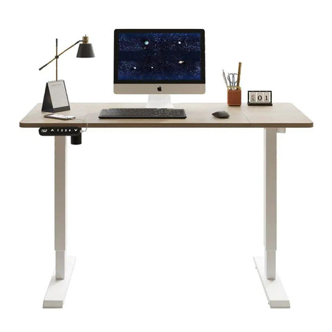 Electric Standing Desk with Solid Steel Frame And Smooth Height Adjustment For Home Office Gaming Setup That Rocks A Sleak Oak Finish, workspace view with monitor and accessories.