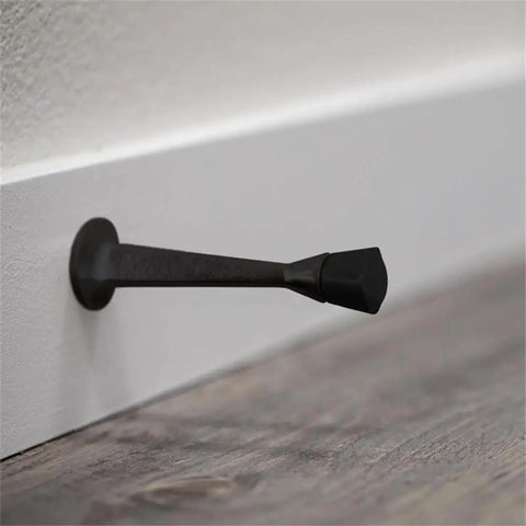10 Pack Stainless Steel Cast Door Stops 3 Inch Matte Black Finish With White Rubber Stopper wall mounted close-up view