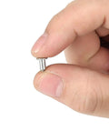 Heavy Duty 6.5mm Tire Stud Inserts 100 Piece Anti Slip Kit for Cars Trucks And ATVs held in hand for winter traction.