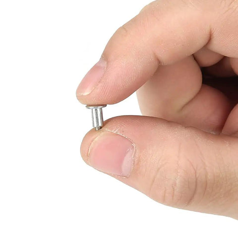 Heavy Duty 6.5mm Tire Stud Inserts 100 Piece Anti Slip Kit for Cars Trucks And ATVs held in hand for winter traction.