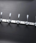 Two Piece Five Hook Wall Mounted Coat Rack Made From Solid Stainless Steel Featuring A Polished Mirror Finish, on a black surface.