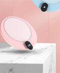 Ditch Cold Coffee And Keep Your Morning Brew Piping Hot With This Electric Mug Warmer in pink with digital display on marble.