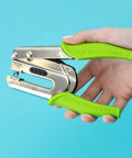 Hand holding Crop-A-Dile Power Punch for one quarter inch holes scrapbooking tool for paper, leather, and fabric DIY projects.