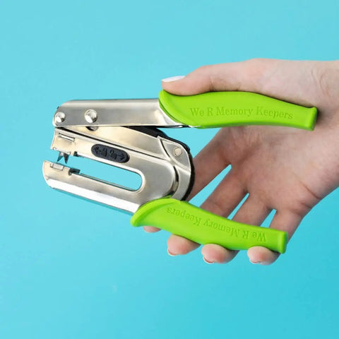 Hand holding Crop-A-Dile Power Punch for one quarter inch holes scrapbooking tool for paper, leather, and fabric DIY projects.