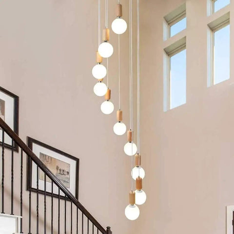 Top Shelf Three Head Disc Pendant Ceiling Light With Milky Frosted Glass Lampshades And Heavy Duty Wrought Iron Frame hanging in a stairwell.