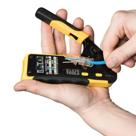 Hand using crimping tool to install Modular Data Plug For CAT6A And Thicker CAT6 Cables, No Fuss Fast Pass Thru Install Ethernet Kit