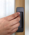 Hand using Self Stick Instant Cabinet Drawer Handle Multipurpose Stick On Handle For Kitchen Cabinets Doors And Windows Easy Opening
