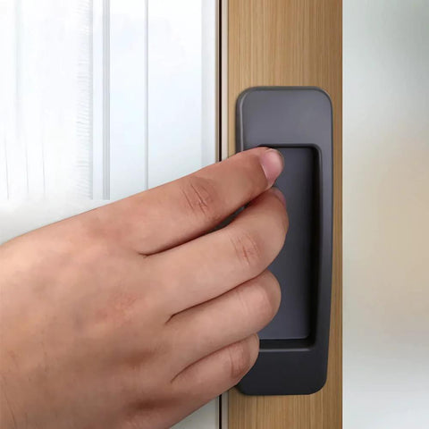 Hand using Self Stick Instant Cabinet Drawer Handle Multipurpose Stick On Handle For Kitchen Cabinets Doors And Windows Easy Opening