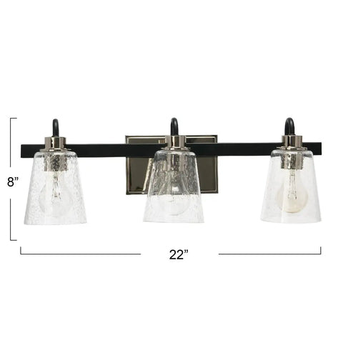 Front view of Three Light Vanity Fixture With Seeded Glass Diffusers Matte Black Finish With Polished Nickel Accents Sleek Industrial Vibe