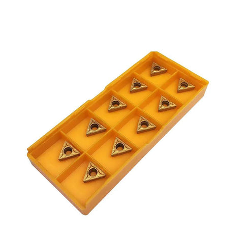 Angled top view of yellow plastic organizer with 12 TCMT-style carbide turning inserts.