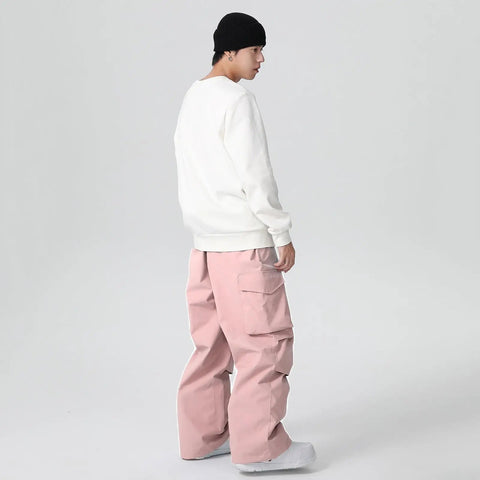 Men wearing Men's Waterproof Insulated Ski Pants With Baggy Snowboard Style Fit in pink for winter outdoor sports