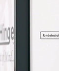 Close-up of Hella Easy Invisible Picture Frame Hinges For Wall Safes showing undetectable hardware on a white wall.