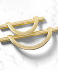 Brushed Gold Half Moon Cabinet Pulls Set of 2, 3.75 Inch Length, zinc alloy handles on a marble surface