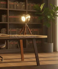 Dope Vintage Industrial Tripod Table Lamp With Teak Wood Base, Brown Brass Finish, And Rustic Gold Accent in home office.