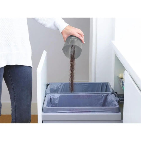 Person emptying dirt from Compact Lithium Hand Vacuum Kit With 2Ah Battery For Cars And Home Multi Surface Cleaning Easy View Dirt Bowl