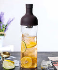 This Straight Up Game Changing 800 Ml Cold Brew Coffee Maker Doubles As A Portable Iced Espresso Glass Bottle With Leakproof Tea Infuser Designed For Boss Level Chilled Sips Anywhere You Head filled with iced tea and citrus slices.