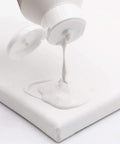 Premium White Texture Gesso 250ml for Artists being poured onto canvas creating smooth surface for mixed media