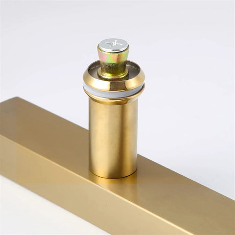 Close-up of a golden fitting component attached to a square tube, not a Beefy Stainless Steel Door Pull Handle For Glass And Wooden Doors.