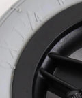 Close-up of Absolute Game Changer 6 Inch Wheelchair Front Wheel Replacement with rubber tire details and black wheel design.