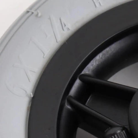 Close-up of Absolute Game Changer 6 Inch Wheelchair Front Wheel Replacement with rubber tire details and black wheel design.