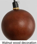 Detail of Travertine Pendant Light Spherical Walnut Wood Hanging Lamp Natural Stone modern fixture with gold accent.