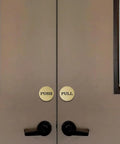 Two Inch Round Push Pull Door Signs Brushed Gold Set Of Two Durable Plastic With Strong Adhesive Foam Tape For Super Easy Install And Clear Legible Messaging In Offices Homes Or Commercial Doors. on double doors