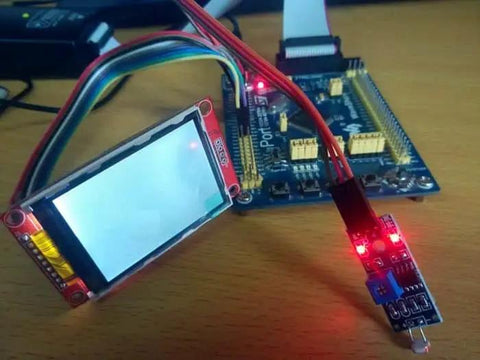 Six Pack 5mm LDR Light Sensor With LM393 Digital DO And Analog AO Output connected to a development board on a table