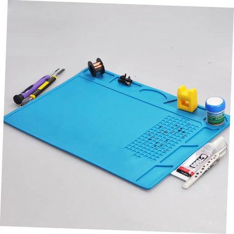Top Notch Silicone Repair Mat With Heat Resistant Non Slip Surface And Precision Pin Layout For Soldering Stations Laminating Machines And No Sweat Tech Fixes with tools and components arranged.