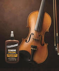 Top Tier Liquid Hide Glue For Fine Woodworking And Furniture Restoration Quick Setting Reversible Adhesive 8 Ounce Bottle next to a violin.
