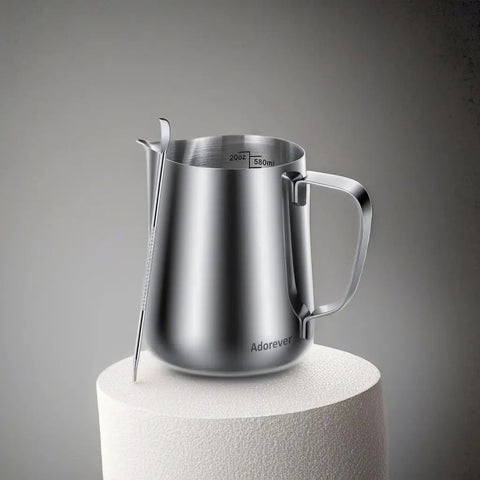 20oz Stainless Steel Milk Frothing Pitcher With Latte Art Pen For Home Espresso Machines And Coffee Bars on a pedestal