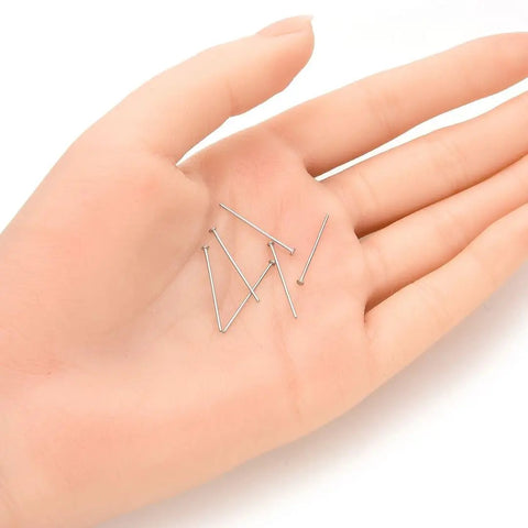 Hand holding 200 Pieces 304 Stainless Steel Flat Head Pins 20mm 0.8 Inch 21 Gauge Jewelry Making Pins Waterproof Hypoallergenic Tarnish Free Durable Craft Supplies for DIY Projects