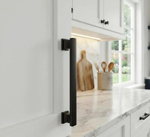 25 Pack Flat Black Cabinet Pull Handles, 4 Inch Center-To-Center, close-up installed on white kitchen cabinet door