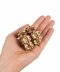 Hand holding Flexi-Cubus 2.0 Octasphere Puzzle 3D Mechanical Wooden Model, steampunk wooden skeleton cube