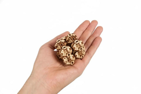 Hand holding Flexi-Cubus 2.0 Octasphere Puzzle 3D Mechanical Wooden Model, steampunk wooden skeleton cube