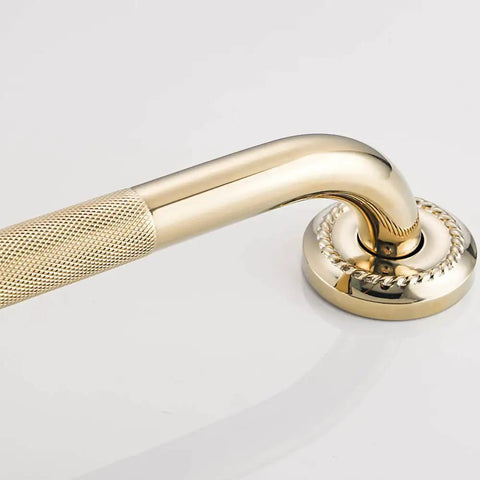 Close-up of textured shower grab bar 16 inch bathroom support rail with polished brass finish for seniors and kids.