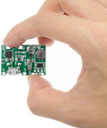 Six Pack TP4056 Battery Charger Module With Dual USB Boost Circuit For 18650 Lithium Ion Packs in hand, showcasing its compact size.