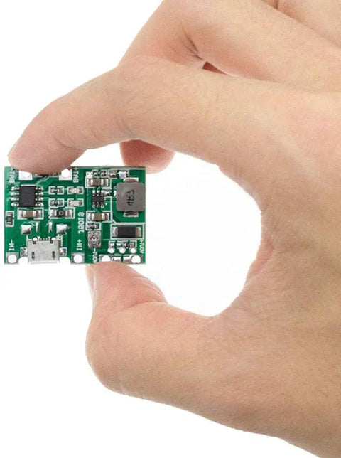 Six Pack TP4056 Battery Charger Module With Dual USB Boost Circuit For 18650 Lithium Ion Packs in hand, showcasing its compact size.