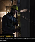 Worker using LED Lighted Level With Illuminated Vials For True Plumb And Level Readouts in a dim construction site.