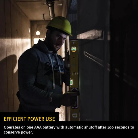 Worker using LED Lighted Level With Illuminated Vials For True Plumb And Level Readouts in a dim construction site.