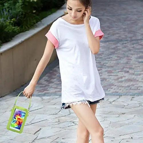 Young woman walking outdoors with a green smartphone pouch, wearing a white t-shirt and shorts, on a stone path.