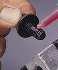 Loctite 263 red automotive threadlocker applied to a small steel bolt with washer; close-up view