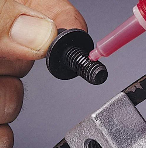 Loctite 263 red automotive threadlocker applied to a small steel bolt with washer; close-up view