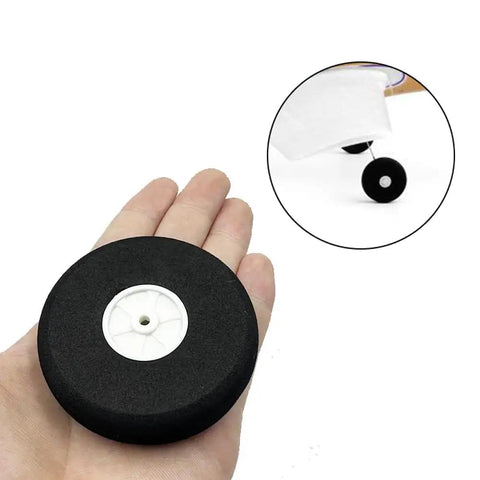 Hand holding 4 Pcs 2.75 Inch RC Airplane Wheels Set With Light Foam Tires Pro Grade Ultra Lightweight Sponge Wheels for planes
