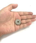 Smooth As Butter V Groove Pulley With Sealed Bearing Steel Rollers And Low Noise Guide Rail Ball Bearings 5 X 22 X 5 Millimeter in a hand.