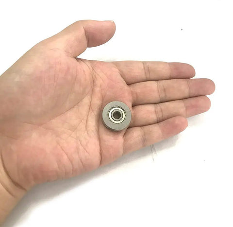 Smooth As Butter V Groove Pulley With Sealed Bearing Steel Rollers And Low Noise Guide Rail Ball Bearings 5 X 22 X 5 Millimeter in a hand.