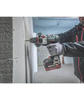 Professional Heavy Hitter 18V Brushless Cordless Hammer Drill Driver Set Includes Two 52Ah Lithium Ion Batteries Quick Charger in action drilling through a wall.