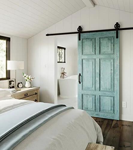 Decorative Interior Sliding Barn Door Hardware Spoke Wheel Kit For 72 Inch Doors In Oil Rubbed Bronze Includes All Mounting Hardware For Easy Installation Perfect For Rustic Gate Shed Or Stall Doors Adds Privacy And Style shown installed in a bedroom.