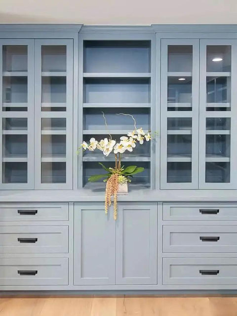 10 Pack 3 Inch Center To Center Oil Rubbed Bronze Cabinet Cup Pulls showcased on blue cabinets with modern floral decor.