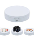 Mcbazel 5.4 Inch Motorized Rotating Display Stand With 360 Degree Electric Turntable showcasing a camera, rings, and a watch.